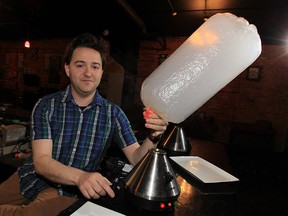 Jon Liedtke, co-owner of Higher Limits cannabis vaping lounge in downtown Windsor, demonstrates use of one of the establishment's medical grade vaporizers.