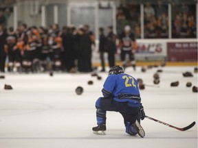 Amherstburg's Kasey Basile watches as the Essex 73's celebrate after defeating the Amhersburg Admirals  5-4 in Game 7 of the Great Lakes Junior C final on March 20, 2016.