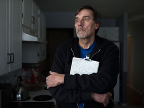 Mike Provost, 62, is pictured with his notes on the Windsor Hum in his home in Sandwich, Wednesday, March 2, 2016.  Provost has been monitoring the Windsor Hum for nearly four years and feels the hum has been more frequent in the last three months.