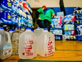Volunteers sort through cases of water donated at the Flint Boys and Girls Club on Saturday, Feb. 20, 2016 in Flint, Mich.