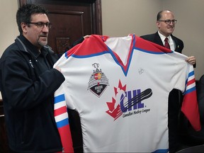 Steve Horne (L) director of business development for the Windsor Spitfires and Windsor Mayor Drew Dilkens pose with a jumbo jersey on Thursday, March 24, 2016, that will part of the city's bid to host the 2017 Memorial Cup.