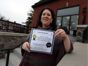Kingsville BIA co-ordinator Sarah Holland displays a poster on March 23, 2016 to officially launch a program to acknowledge employees of local businesses who offer exceptional customer service.