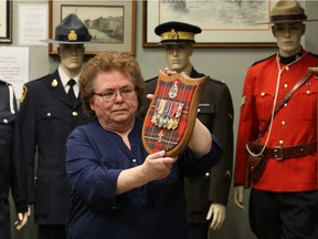 Katherine Gunning holds treasured war medals of Pte. E.J. Thibert, Essex Scottish Regiment, who served during the Battle of Dieppe on March 9, 2016 at Kingsville's Military Museum and Historical Park on Division Road South.