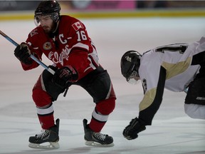 Leamington Flyers' captain Mitchell Amante avoids a check by LaSalle Vipers' Nathan Veres during Junior B playoff action at the Vollmer Centre on April 1, 2015.