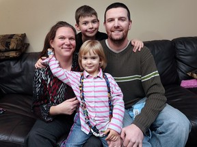 Aaron and Melanie McCallum are shown with their kids Lexie, 3, and Billy, 9, at their Windsor, Ont., home on Thursday, March 24, 2016.