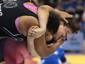 Tatyanna Foster, left,  of Turner Fenton Secondary School in Brampton, and Dayjanea Johnson of Sandwich Secondary compete during the gold medal match on Wednesday, March 2, 2016, at the OFSAA wrestling championships at the WFCU Centre in Windsor.