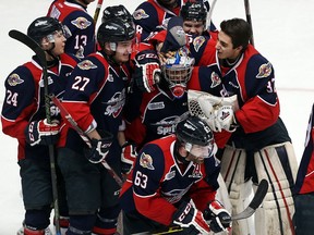 The Windsor Spitfires celebrate the overtime goal by Bradley Latour to beat the Kitchener Rangers in the Ontario Hockey League playoff game at the WFCU Centre in Windsor, Ont. on March 30, 2016.