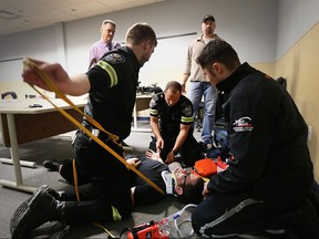EMS Team Ontario medical director Dr. Paul Bradford, back left, and, rescue medicine instructor Thomas LeClair, right, look on as  Windsor-Essex EMS paramedics Chris Kirwan, Lance Hoover, Slav Pulcer, and Nick Montelone train for the International Paramedicine Competition called the Rallye Rejviz.