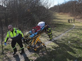 Windsor paramedics and firefighters are shown on a path between University Avenue West and Wyandotte Street West just east of Cameron Avenue on Thursday, March 17, 2016. They were responding to a man that was found unconscious near the walkway. They were able to wake the man up and help him into an ambulance. The incident occurred at approximately 10 a.m.