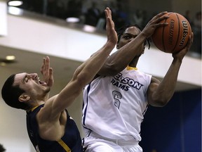 Ryerson Rams Roshane Roberts drives to the net against  Windsor Lancers Mike Rocca in Toronto, Ont. on Friday March 11, 2016.