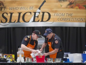 Tecumseh Fire Rescue Service deputy Chief Chad Mactier, left, and Tecumseh firefighter Mike D'Aloisio participate in Sliced, a community cook-off organized by the Windsor-Essex County Health Unit, at Devonshire Mall, Saturday, March 19, 2016.