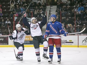 Windsor's Cristiano DiGiacinto and Cole Carter, left, celebrate DiGiacinto's first period goal while Kitchener's Darby Llewellyn looks on during OHL action between the Windsor Spitfires and visiting Kitchener Rangers at the WFCU Centre, Sunday, Dec. 13, 2015.