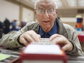 Abie Heersma, 82, looks through antique stamps from the Dutch colonies at WINPEX, hosted by the Essex County Stamp Club at the Caboto Club, Saturday, March 12, 2016.  Heersma has been a stamp collector for more than sixty years.