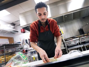 Anas Lafi, a Syrian refugee who recently settled in Windsor, Ont. is shown at his job at the Kabobgy restaurant in LaSalle. He works as a cook at the business and started there shortly after arriving in Windsor last October.