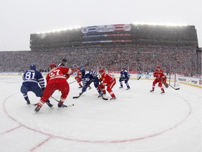 The Toronto Maple Leafs and the Detroit Red Wings face off during Winter Classic at Michigan Stadium in Ann Arbor, Mich., Wednesday, Jan. 1, 2014.