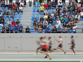 Runners compete in heat one of the senior men's 200m dash at the OFSAA West Track and Field competition at Alumni Field in this June 2012 file photo.