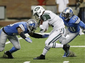 Detroit Lions safety Trevor Coston, left, and cornerback Bill Bentley (28) close in on New York Jets wide receiver Jeremy Kerley (11) during a preseason football game at Ford Field in Detroit on Aug. 9, 2013.