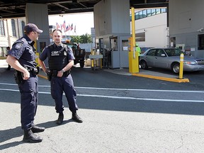 U.S. Customs and Border Protection officers stand at the U.S. side of the Detroit-Windsor Tunnel in this 2013 file photo.