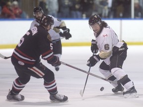 LaSalle's Allen Cale and Sarnia's Derrick Johnson, left, battle for the puck during Game 7 of their first-round Jr. B playoff series at the Vollmer Centre, Sunday, March 13, 2016.