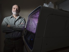 Dr. Dan Heath stands next to an ion Torrent at the Great Lakes Institute for Environmental Research at the University of Windsor, Tuesday, March 1, 2016.  The ion Torrent uses DNA sampling to test water for bacteria composition.