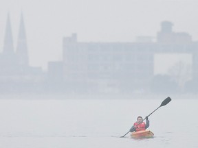 Paul Rumiel takes advantage of the unseasonably warm weather by kayaking on the Detroit River in this file photo.