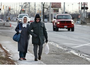 In this file photo, Irene Tremblay and her husband Charles Tremblay head north on Dougall Avenue near Dorwin Plaza, on Jan. 21, 2008, after picking up a few groceries. (Weather cruiser). The Windsor Star - Nick Brancaccio