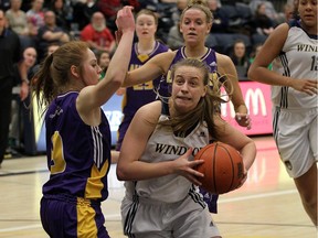 The University of Windsor Lancers Kaylee Anagnostopoulos drives into the Laurier Golden Hawks Amanda Milanis at the St. Denis Centre in Windsor on Wednesday, March 2, 2016.