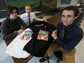 L'Essor students Mitchell Daudin, Zak Brochu and Evan Hooper (left to right) display some shirts from their clothing line at L'Essor high school in Tecumseh on March 23, 2016.
