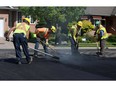 WINDSOR, ON. MAY 22, 2015. --  A paving crew lays asphalt in the east end of Windsor on Friday, May 22, 2015.              (TYLER BROWNBRIDGE/The Windsor Star)