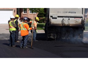 In this file photo, a paving crew lays asphalt in the east end of Windsor on Friday, May 22, 2015.              (TYLER BROWNBRIDGE/The Windsor Star)