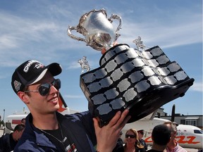 Goaltender Andrew Engelage holds the Memorial Cup at Windsor Airport where the Memorial Cup champion Windsor Spitfires arrived home from Rimouski, Quebec, Monday, May 25, 2009.