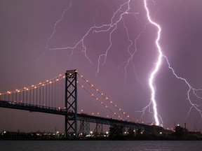 Lightning strikes near the Ambassador bridge in Detroit, Michigan during a heavy thunderstorm on March 12, 2016.