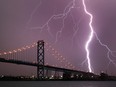Environment Canada has issued an evening thunderstorm warning, which could include lightning strikes like this one near the Ambassador bridge on March 12, 2016.