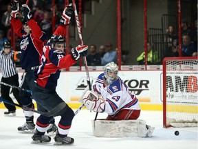 The Windsor Spitfires celebrate a goal against Kitchener Rangers goaltender Luke Opilka during Ontario Hockey League action at the WFCU Centre on March 17, 2016.