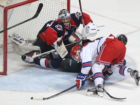 Kitchener Rangers  Connor Hall collides with Windsor Spitfires goaltender Michael DiPietro during the first period of Ontario Hockey League playoff action at the WFCU Centre in Windsor, Ont., on March 28, 2016.