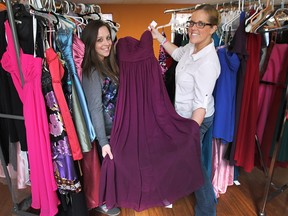 Kristin Durham, left, and Kim Gratto of New Beginnings pose with some prom dresses on March 11, 2015 ahead of the annual Say Yes to the Dress event.