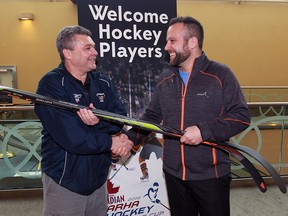 Marty Kerester, left, vice president of Knobby's Kids, thanks CARHA Hockey World Cup co-ordinator Reuben Greenspoon for the generous donations of cash and hockey equipment from the Swiss team HC Luzern Oldies Thursday April 7, 2016. Five HC Luzern players donated their hockey equipment and one player reached for his wallet and donated $50 on the spot.  The team is retiring and heard about Knobby's Kids hockey program.