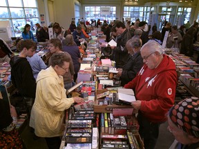 Book lovers browse through boxes of donated books at the Raise a Reader Book Sale (Windsor Star files)