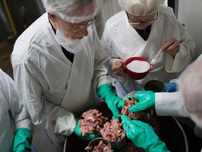 LEAMINGTON, ON.: APRIL 19, 2016 -- Volunteers with the Meat Canner-Leamington Committee can chicken meat for countries in need at the Southwestern Ontario Gleaners in Leamington, Tuesday, April 19, 2016. (DAX MELMER/The Windsor Star)