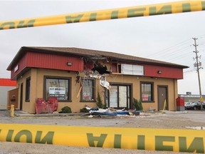 The damage to a building at 256 Talbot St. W. is shown Tuesday, Oct. 23, 2012, in Leamington, Ont. Two men are in hospital with life threatening injuries after the truck they were travelling launch into the air and struck the building at 1:42 am this past Sunday