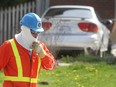 Windsor firefighters had to evacuate a number of residences in the 1200 block of Dougall Ave. on Wednesday, April 27, 2016, after a vehicle struck a home and caused a gas leak. A Union Gas technician walks in front of the car at the scene. (DAN JANISSE/The Windsor Star)