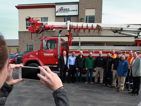 Essex Power Corp. CEO Ray Tracey, right, and other Essex Power employees hand over the keys to a 2000 Freighliner radial boom derrick (RBD) truck to Doug Bendall, centre, Mark Benoit and Joe Schnekenburger of St. Clair College's Powerline Technician program Tuesday April 19, 2016. The $42,000 donation is intended to give students a hands on opportunity while they study to become a powerline technician. (NICK BRANCACCIO/Windsor Star)