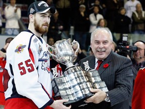 CHL commissioner David Branch presents the Memorial Cup to Harry Young of the Windsor Spitfires during the 2009 final at the Rimouski Colisee on May 24, 2009 in Rimouski, Que.