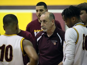 Cath. Central Comets head coach Peter Cusumano, centre, talks to players during game against Kennedy Clippers at Catholic Central High School gym January 5, 2016.