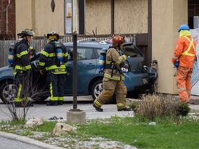 A car backed into a gas line in the 1400 block of Ouellette Avenue in Windsor, Ont. on Monday, April 4, 2016. Fire crews worked to close off the gasoline as well as move the car.