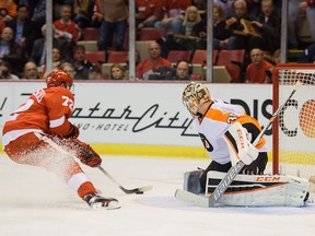 Detroit Red Wings Andreas Athanasiou, left, bears down on Philadelphia Flyers goalie Steve Mason in a break away at Joe Louis Arena in Detroit, Mich. on Wednesday, April 6, 2016. The Wings managed to shut out the Flyers 3-0.