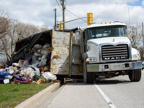 A garbage truck lost its load at the intersection of Riverside Drive East and Starbane Avenue in Windsor, Ont. on Tuesday, April 12, 2016.