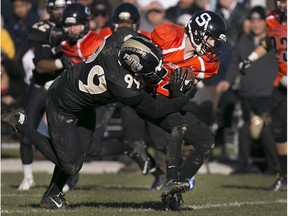 Ottawa's Joey McDonald is wrapped up by AKO's Adam Slikboer during the Ontario Football Conference championship game at E.J. Lajeunesse, on Nov. 1, 2015.  The Fratmen won their third straight title.