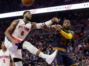 Cleveland Cavaliers forward LeBron James (23) passes around Detroit Pistons center Andre Drummond (0) during the second half in Game 3 of a first-round NBA basketball playoff series, Friday, April 22, 2016 in Auburn Hills, Mich.