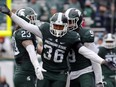Michigan State's Arjen Colquhoun (36) celebrates a play during a game against Purdue on Oct. 3, 2015 in East Lansing, Mich.